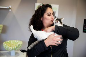 volunteer kissing a kitten